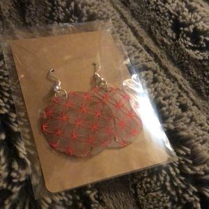 Homemade wooden earrings in shiny red